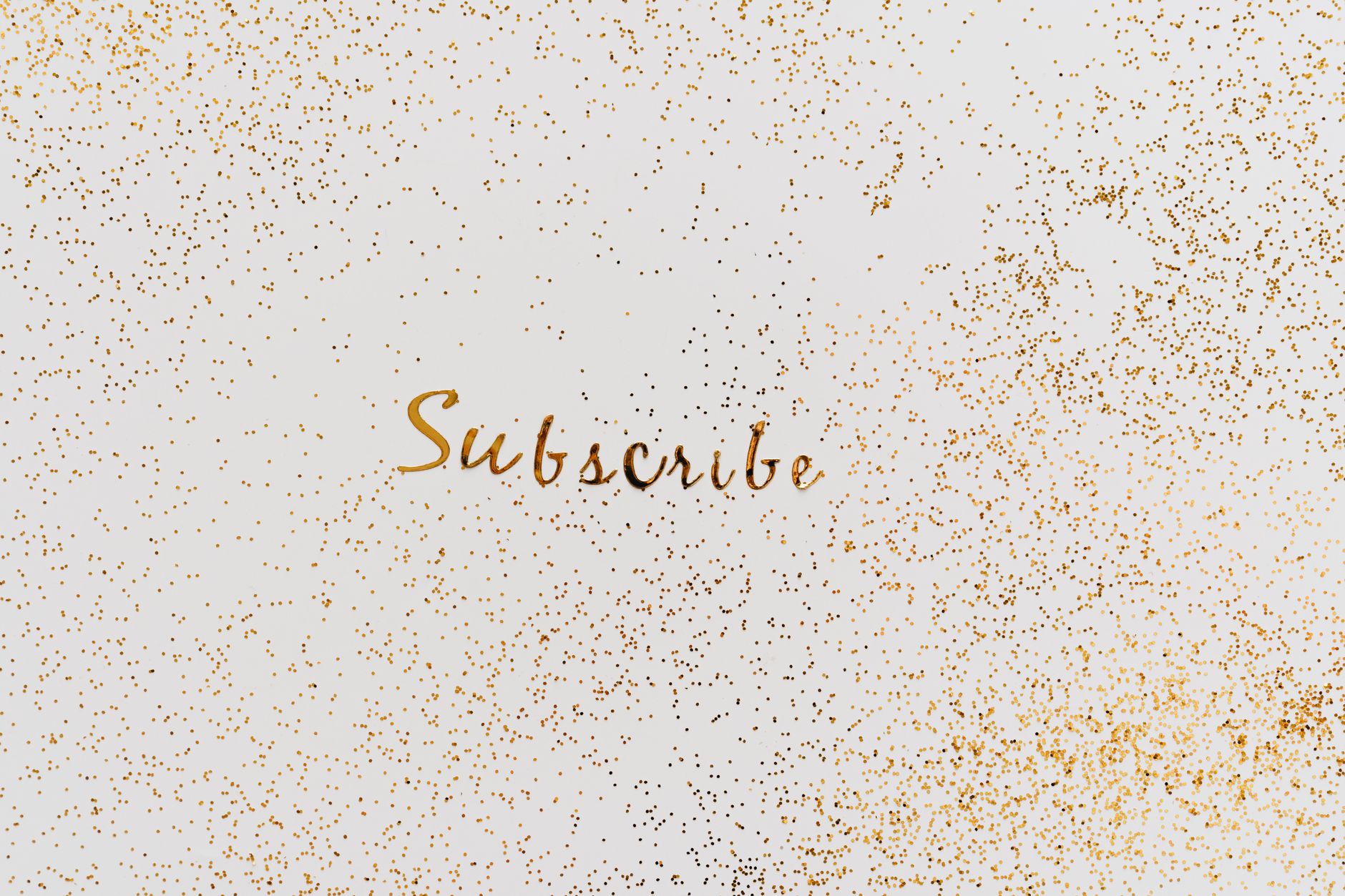 Golden 'Subscribe' text with charming glitter effect on a clean background.