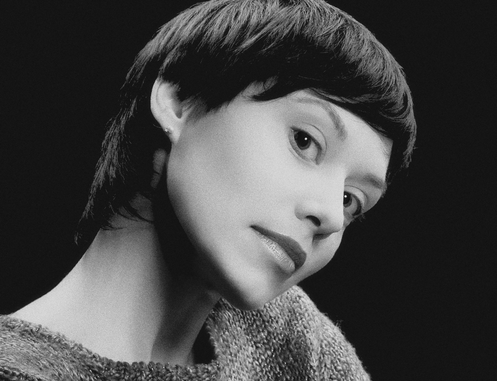 A stunning black and white portrait capturing the elegance of a woman with a classic hairstyle. Perfect for editorial use.